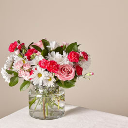 Pink and white mixed bouquet in a clear glass vase