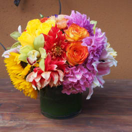 Colorful mixed bouquet in a dark glass vase