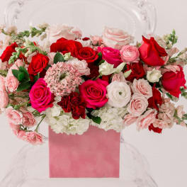 Pink and red rose arrangement in a pink box