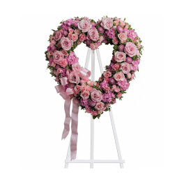 Pink rose heart wreath on a white easel with ribbon