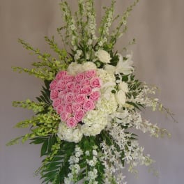 Tall standing floral spray with pink roses and white flowers