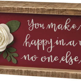 Wooden sign with felt flowers and the phrase "You make me happy in a way no one else can"