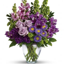 Purple and lavender bouquet in a clear glass vase