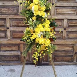 Tall yellow floral spray on a wooden easel