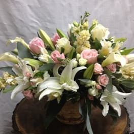 White lilies and pink roses arranged in a basket