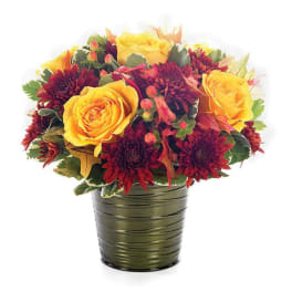 Bouquet of yellow roses and burgundy mums in a ribbed metal vase