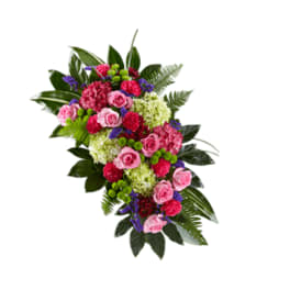 Pink roses and mixed flowers arranged in a cascading spray