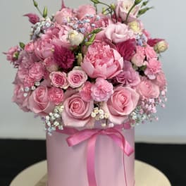 Pink rose bouquet in a round pink box with a ribbon