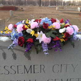 Colorful floral arrangement on a cemetery monument