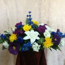 Colorful floral arrangement with white lilies, yellow daisies, and purple blooms