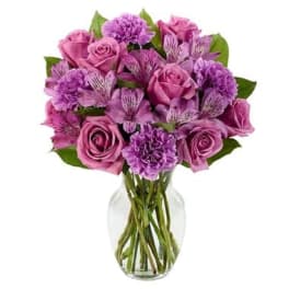 Pink and purple bouquet in a clear glass vase
