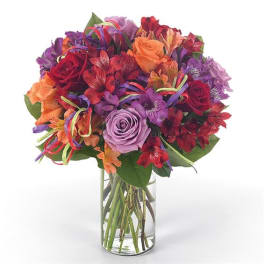 Mixed bouquet of roses and alstroemeria in a clear glass vase