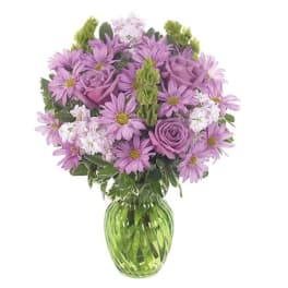 Lavender bouquet of daisies and roses in a green glass vase