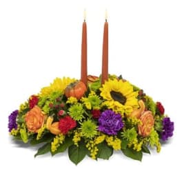 Autumn floral centerpiece with two orange taper candles
