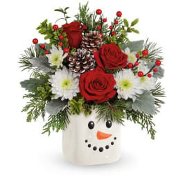 Christmas bouquet in a snowman vase with red roses and white daisies