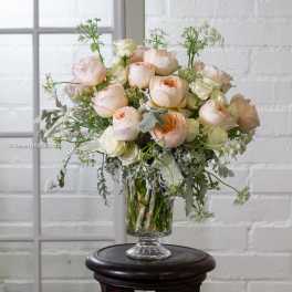 Blush and cream roses in a clear glass vase