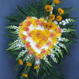 Large standing floral spray with yellow and peach blooms