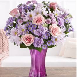 Pink roses and lavender daisies in a purple vase