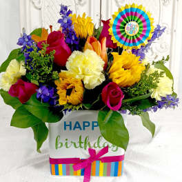Colorful birthday flower arrangement in a decorated gift box