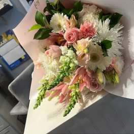 Pink and white mixed bouquet wrapped in pale paper