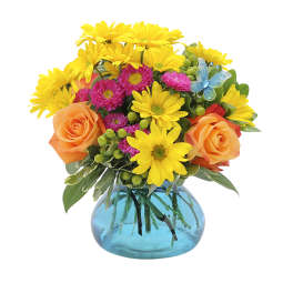 Bouquet of yellow daisies and orange roses in a blue glass vase
