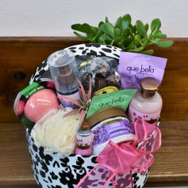 Gift basket with bath products and a small succulent arrangement