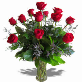 Red roses arranged in a clear glass vase