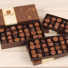 Boxes of assorted chocolates in brown gift packaging