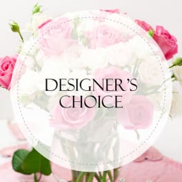 Pink and white roses in a glass vase with "Designer’s Choice" text overlay