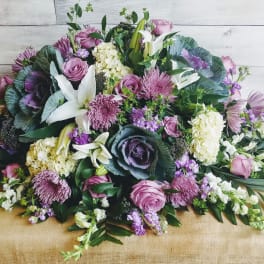 Large bouquet of pink, purple, and white flowers with greenery