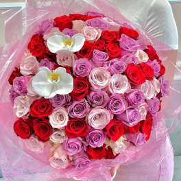 Large bouquet of red, pink, and lavender roses with white orchids