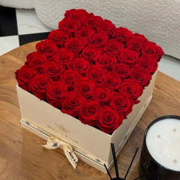 Box of red roses arranged in a square gift box