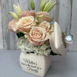 Cream roses and lilies in a heart-shaped keepsake box with a Mother's Day message