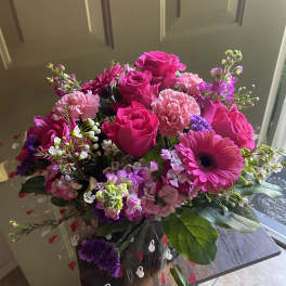 Pink roses and mixed blooms in a clear wrap