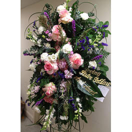 Tall standing floral spray with pink and white roses and purple accents