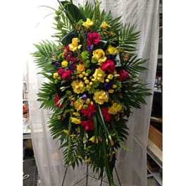 Tall standing floral spray with yellow, pink, and purple flowers