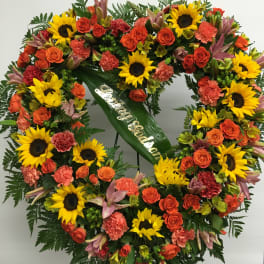 Heart-shaped floral wreath with sunflowers and orange roses