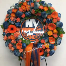 Circular floral wreath with orange and blue flowers around a logo sign