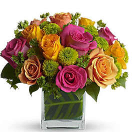 Colorful roses arranged in a clear square vase