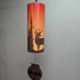Hanging metal wind chime with a deer and pine tree silhouette
