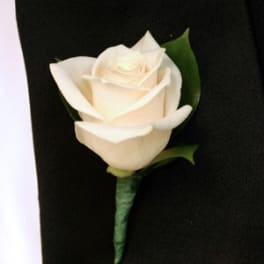 White rose boutonniere on a black suit jacket