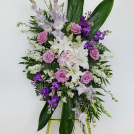 Standing floral spray with pink and white flowers on an easel