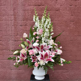 Pink and white floral arrangement in a white vase