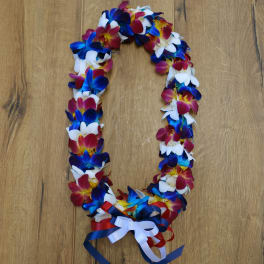 A colorful flower lei with blue, white, and pink blossoms and ribbon ties.
