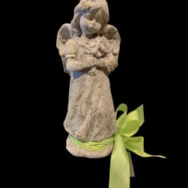 Stone angel figurine with a green ribbon bow