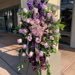 Tall standing floral spray with pink roses and purple flowers