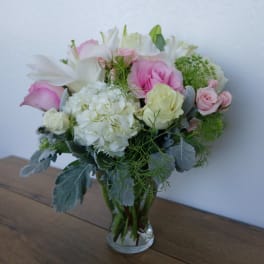 Pink and white bouquet in a clear glass vase