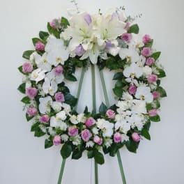 White and pink floral wreath on a standing easel