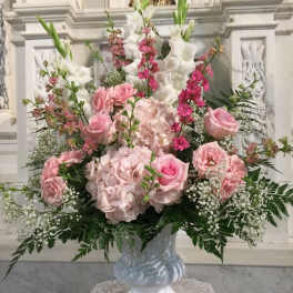 Pink and white floral arrangement in a glass vase
