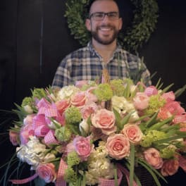 Large basket arrangement of pink roses and white blooms with gingham ribbons